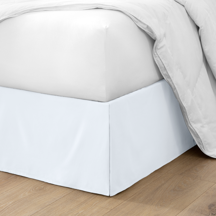Bed with a white pleated bed skirt