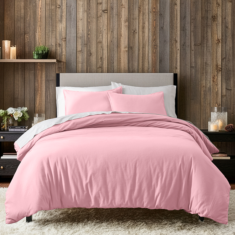 Bed with a pink flannel duvet cover and pillows