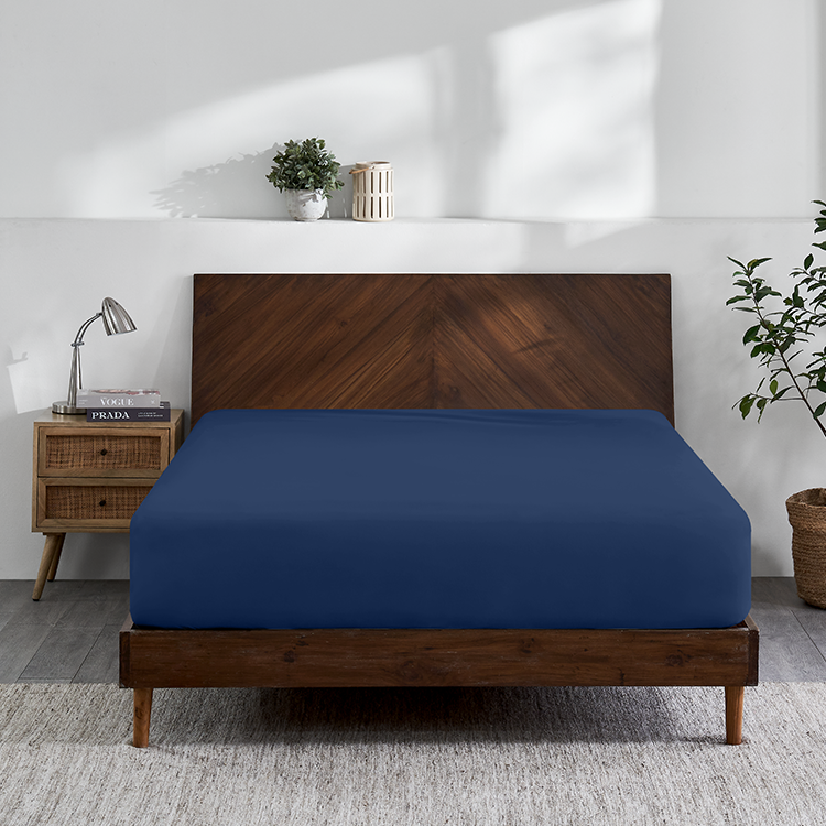Bed with navy blue Organic Cotton Jersey Fitted Sheet and wood bed frame