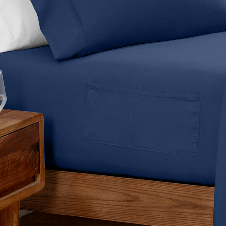 Closeup of navy blue Ultra Soft Dual Side Pocket Fitted Sheet fabric with side pocket detail