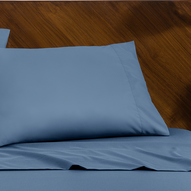 Bed with blue Ultra Soft Envelope Pillowcase Sheet Set, closeup