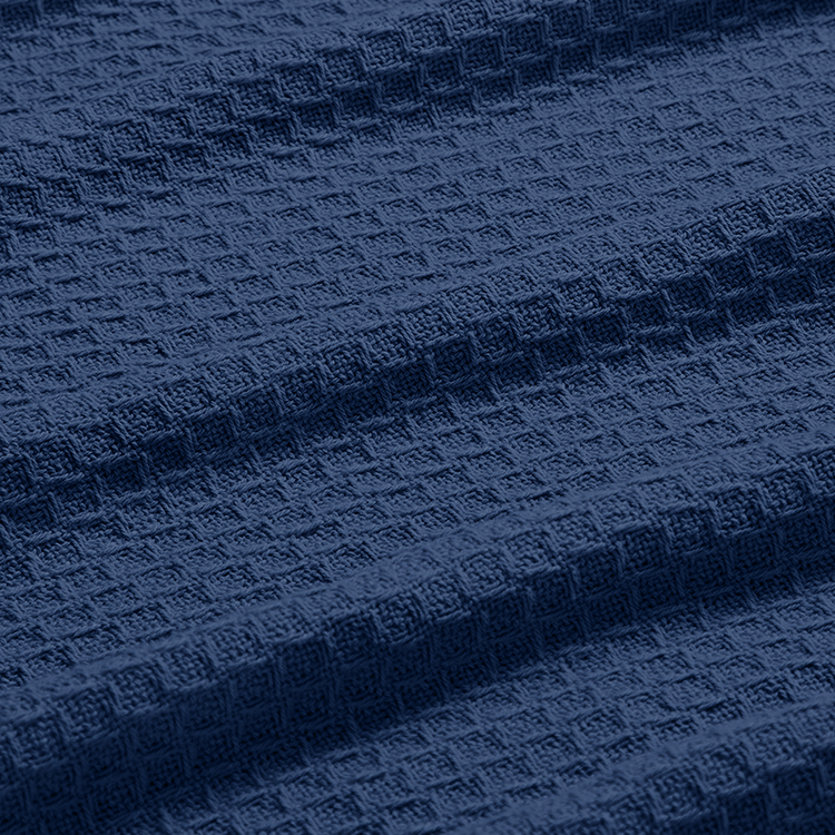 Close-up of navy cotton waffle blanket fabric