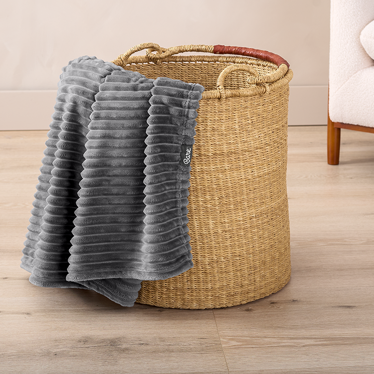 Gray Microplush Ribbed Blanket folded in a basket