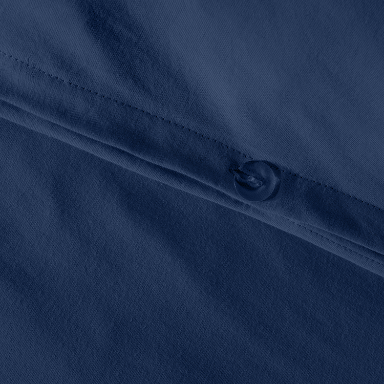 Closeup of navy blue Organic Cotton Jersey Bedding Bundle fabric with snap button closure