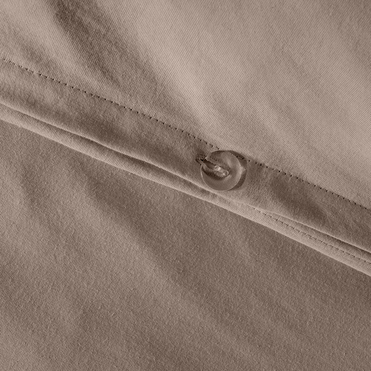 Closeup of taupe Organic Cotton Jersey Duvet Cover Sham Set fabric with snap button closure