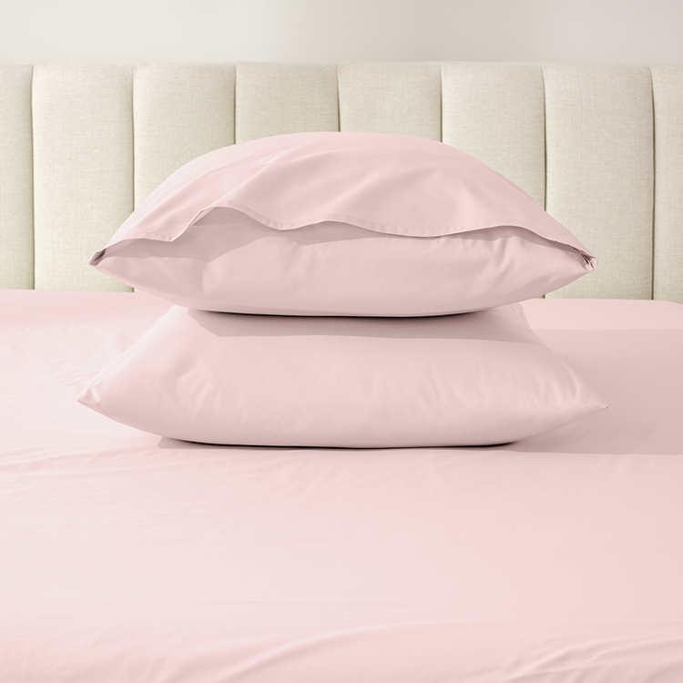 Stack of pillows with pink Organic Cotton Percale Pillowcase Set