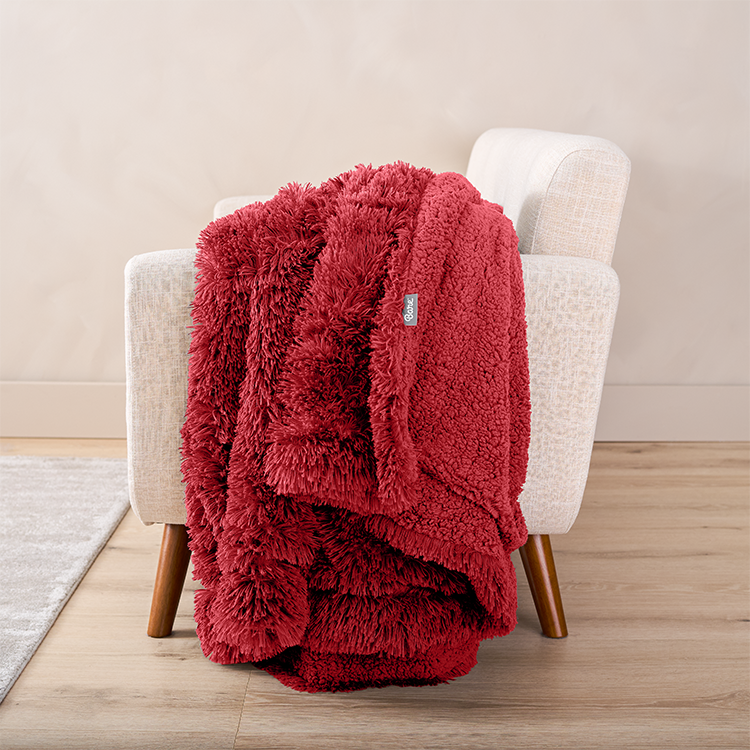 Red Shaggy Faux Fur Sherpa Blanket folded on a chair