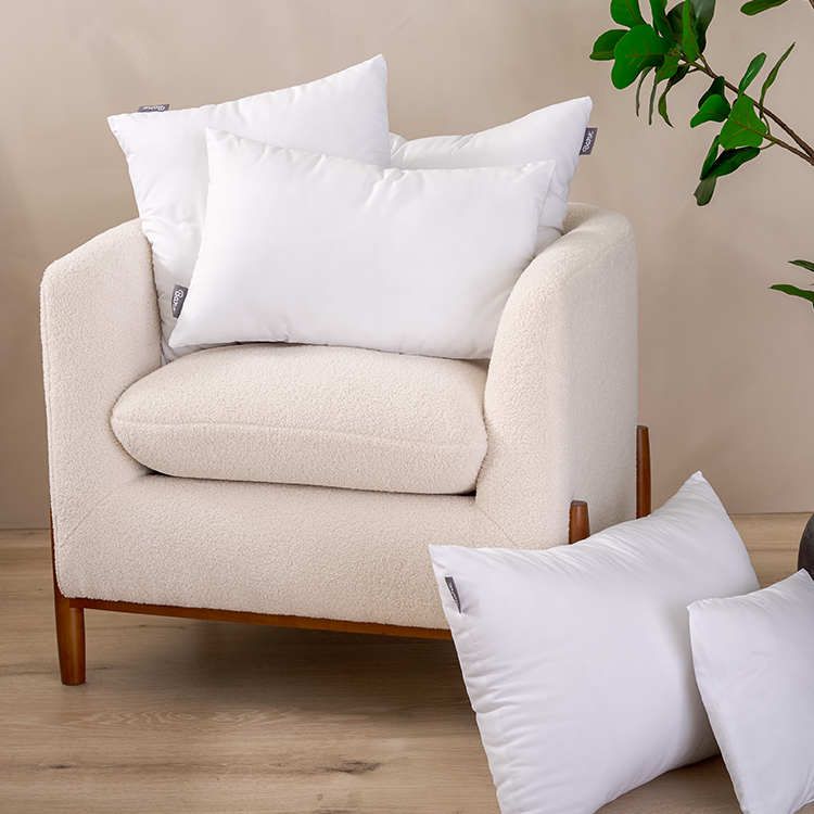 White armchair with a Pillow Insert pillow
