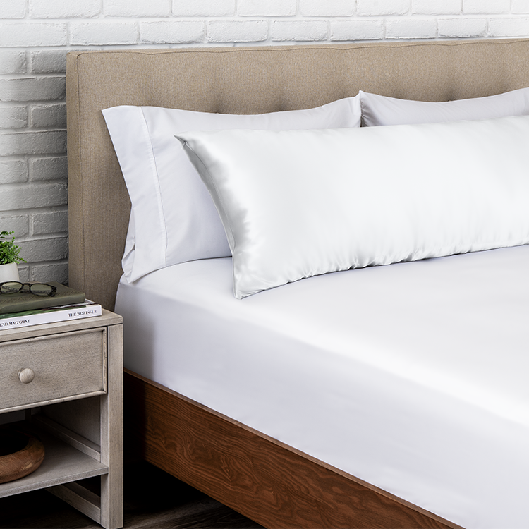 Bed with a white satin body pillowcase