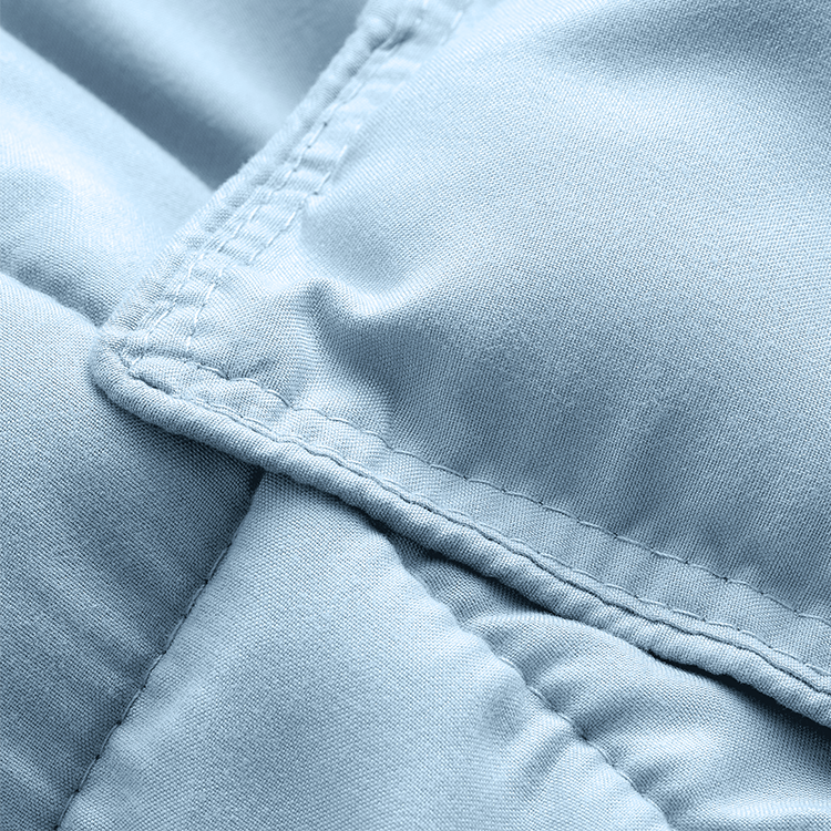 Closeup of light blue Ultra Soft Bed In A Bag fabric with button closure