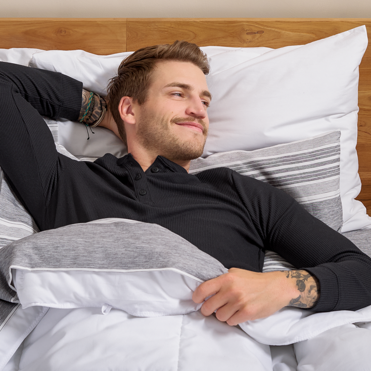 Man relaxing in bed with white Ultra Soft Prints Sheet Set