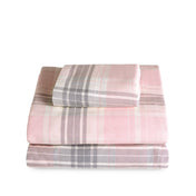 Stack of flannel sheets and pillowcases on a white background