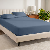 A bed made with a percale fitted sheet