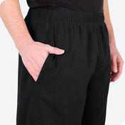 Close-up of a flannel pajama pocket with a man's hand in the pocket.