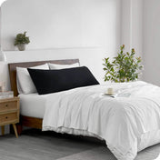 A body pillowcase on a pillow on a bed in a modern bedroom