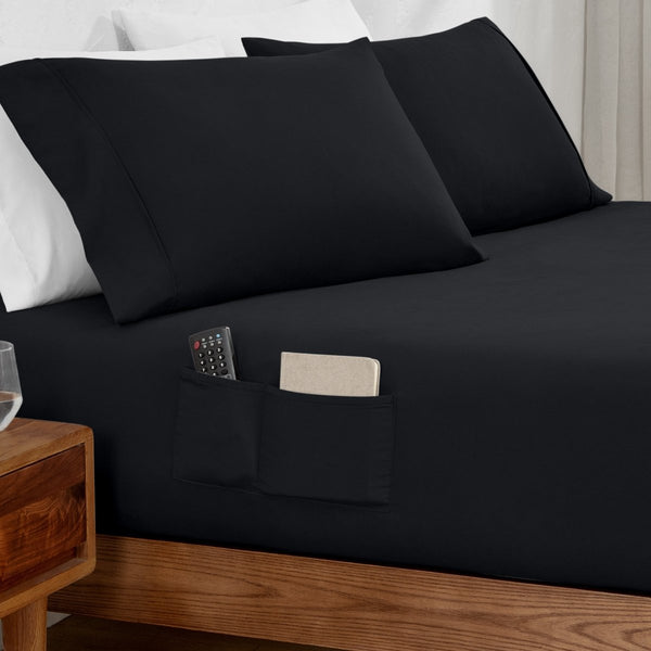 Remote control and journal in the pockets of a fitted sheet