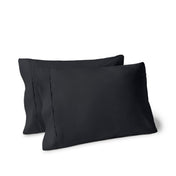 Two pillows on a white background with pillowcases on them