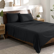 A modern bedroom set with a black sheet set on the bed