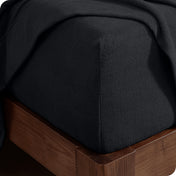 Fitted sheet on a wooden bed frame