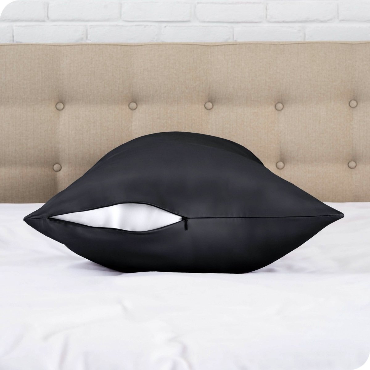 A satin body pillowcase on a bed with white linens
