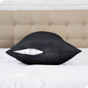 A satin body pillowcase on a bed with white linens