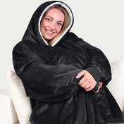 An adult with a sherpa wearable blanket on