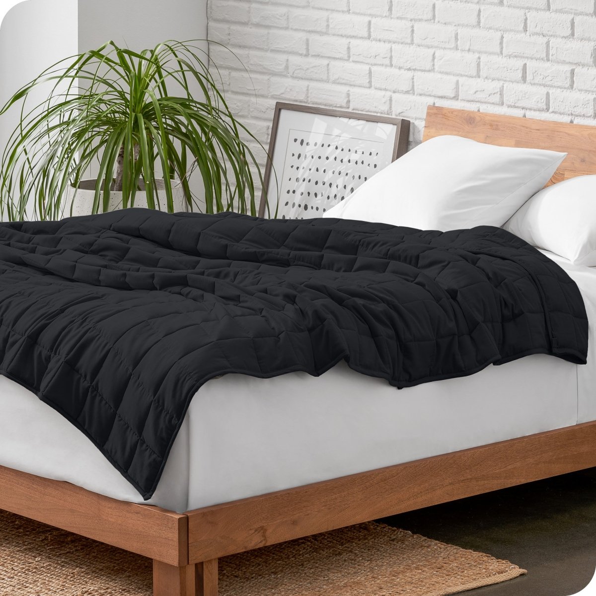 A weighted blanket draped over a bed