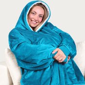 An adult with a sherpa wearable blanket on