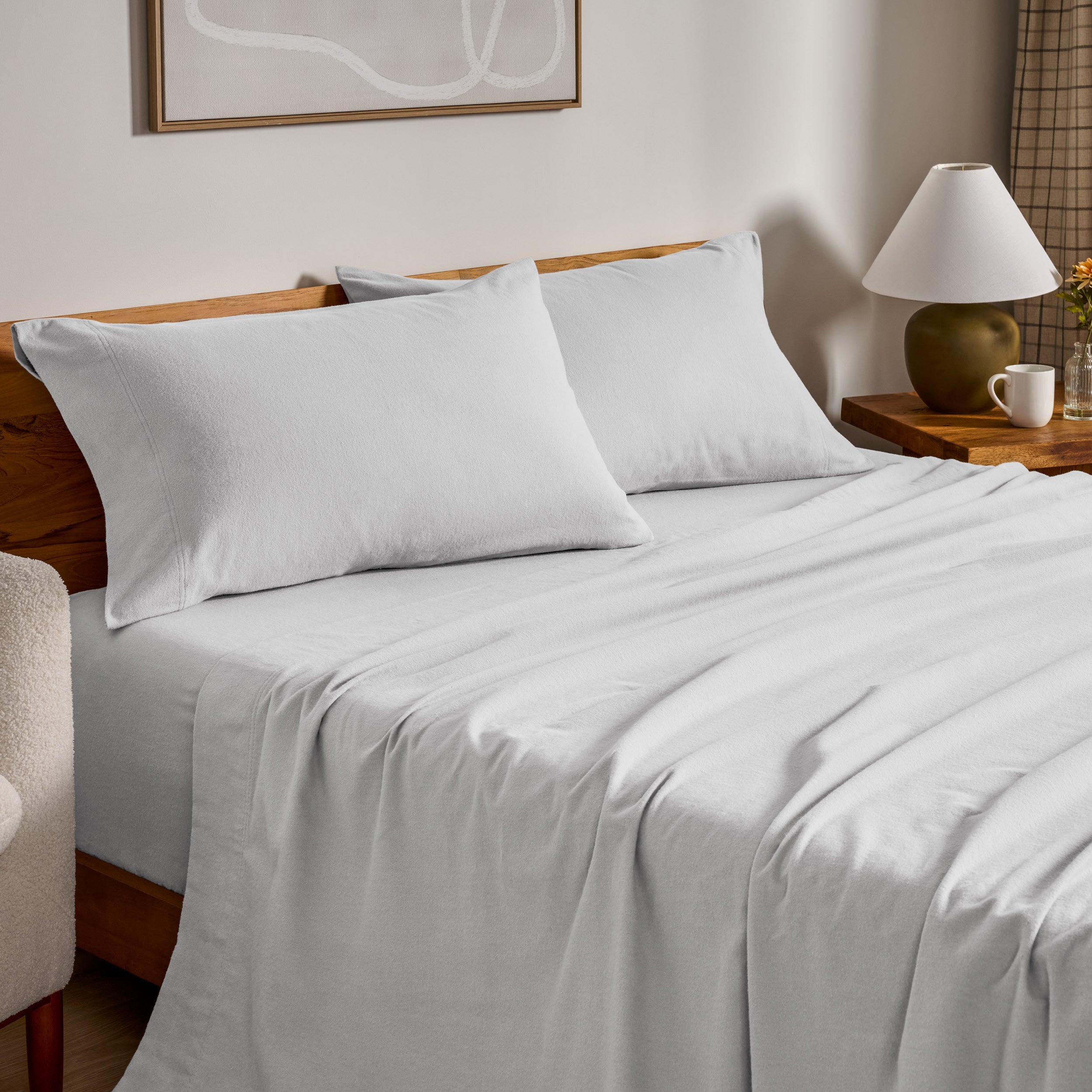 Flannel bed sheets and pillowcases on a bed in a bedroom setting.
