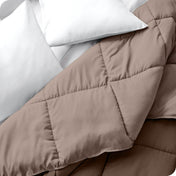 Close up of a comforter folded back to show the different colored sides