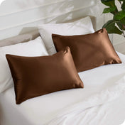 2 mulberry silk pillowcases on pillows set on a bed
