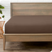 A mattress with just a fitted sheet on it