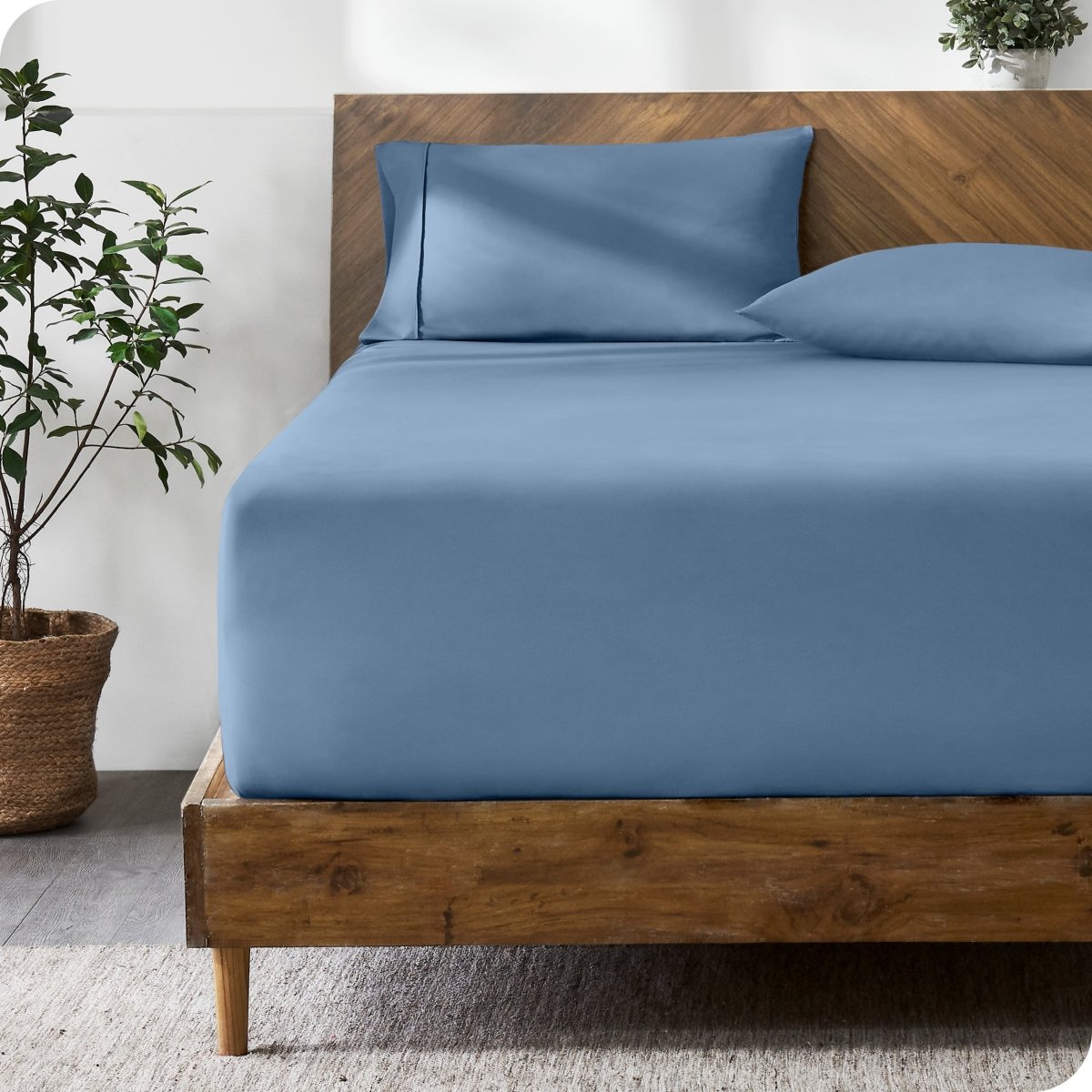 A bed with a fitted sheet and matching pillowcases