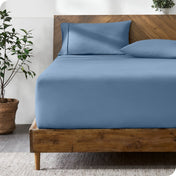 A bed with a fitted sheet and matching pillowcases