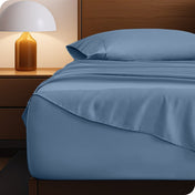 Microfiber bed sheets on a neatly made bed with a wooden headboard and nightstand.