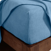 Fitted sheet on a wooden bed frame