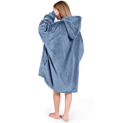 An adult with a sherpa wearable blanket on