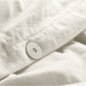 Close up of the button closure on a flannel duvet cover