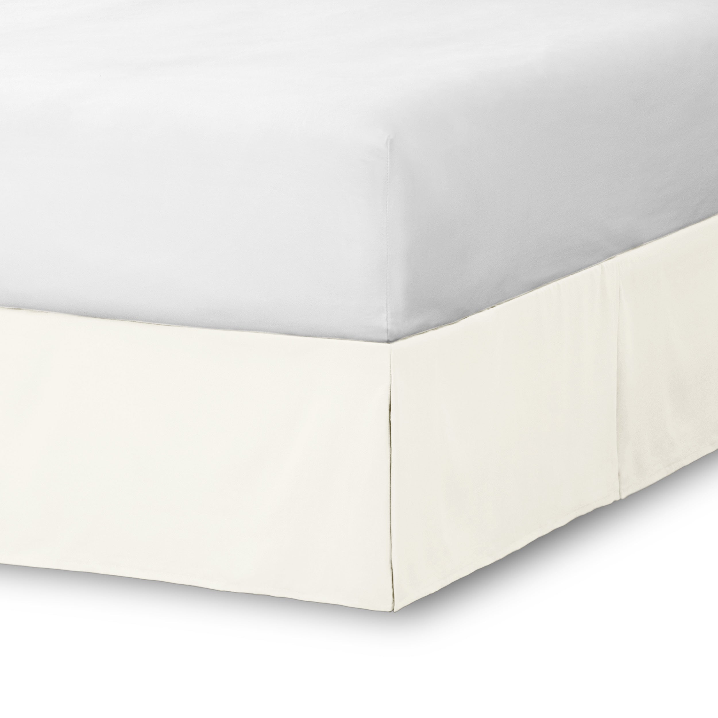 The corner of a bed skirt on a bed frame