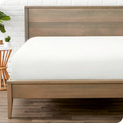 A mattress with just a fitted sheet on it