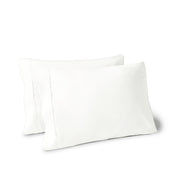 Two pillows on a white background with pillowcases on them