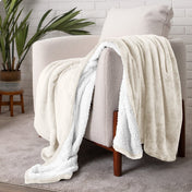 Blanket draped over a chair in a cozy living room setting.