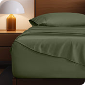 Microfiber bed sheets on a neatly made bed with a wooden headboard and nightstand.