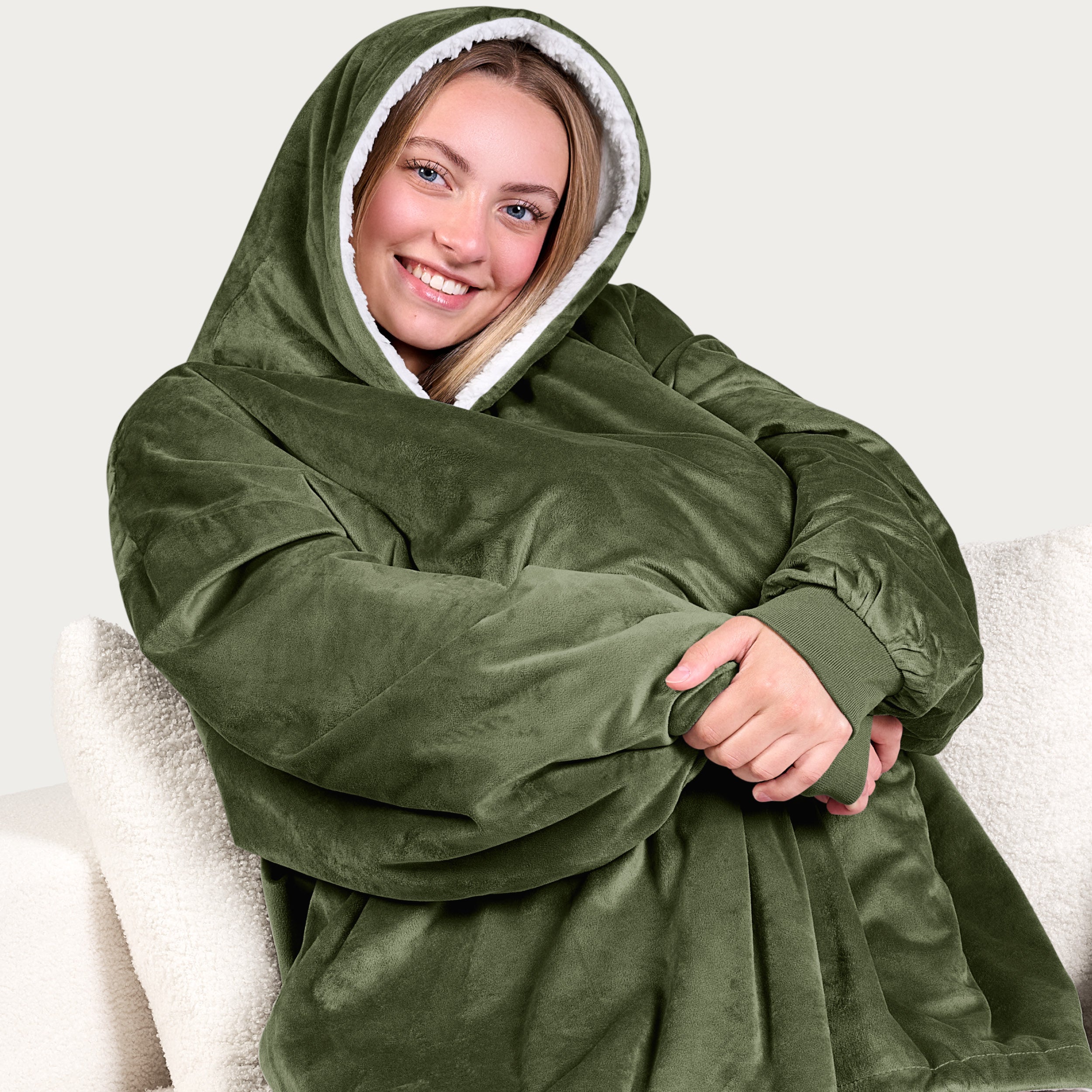 An adult with a sherpa wearable blanket on