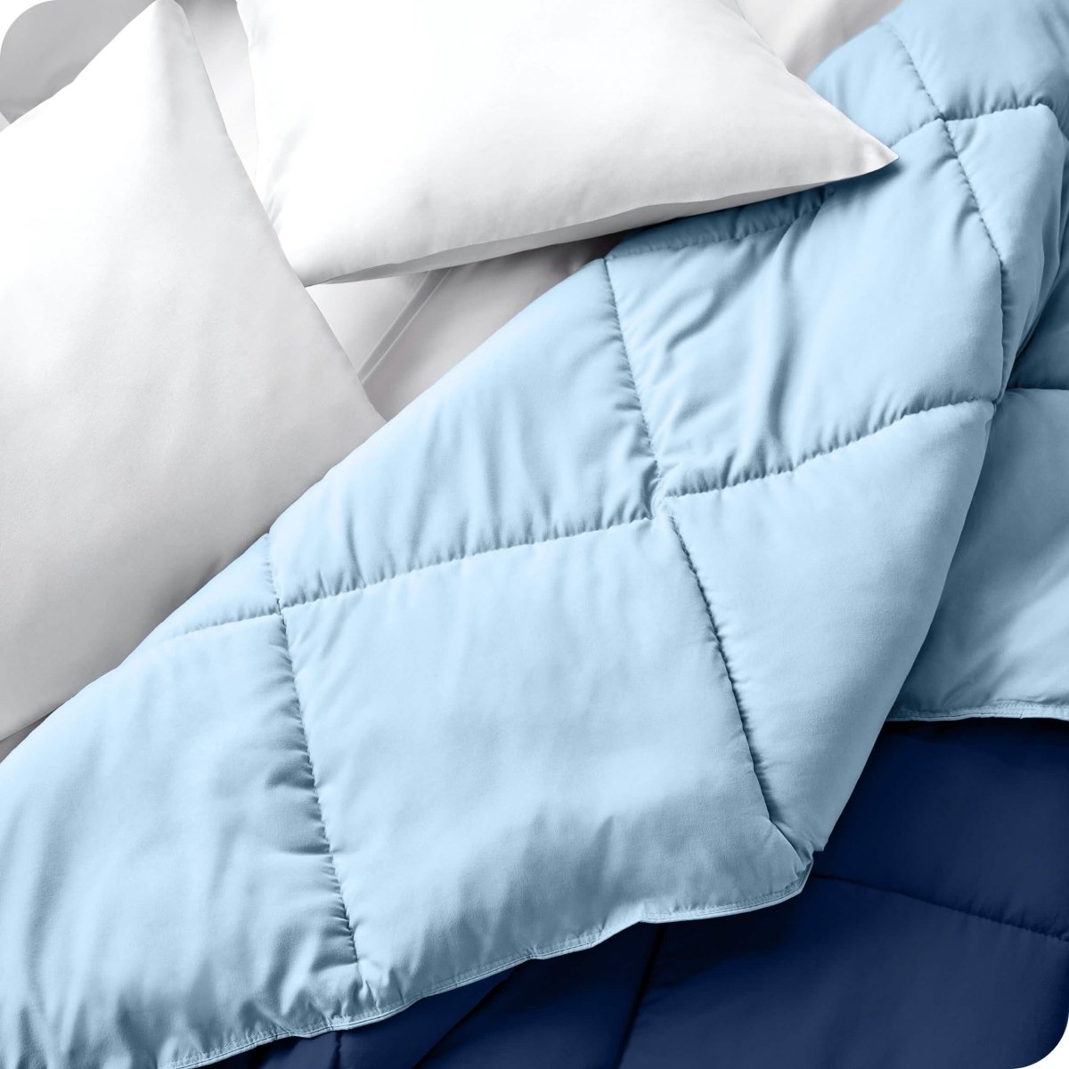 Close up of a comforter folded back to show the different colored sides