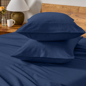 Flannel bedding set on a bed with a beige headboard and lamp.