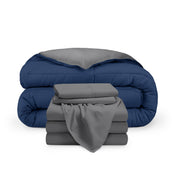 A reversible microfiber comforter and a coordinating sheet set folded and stacked