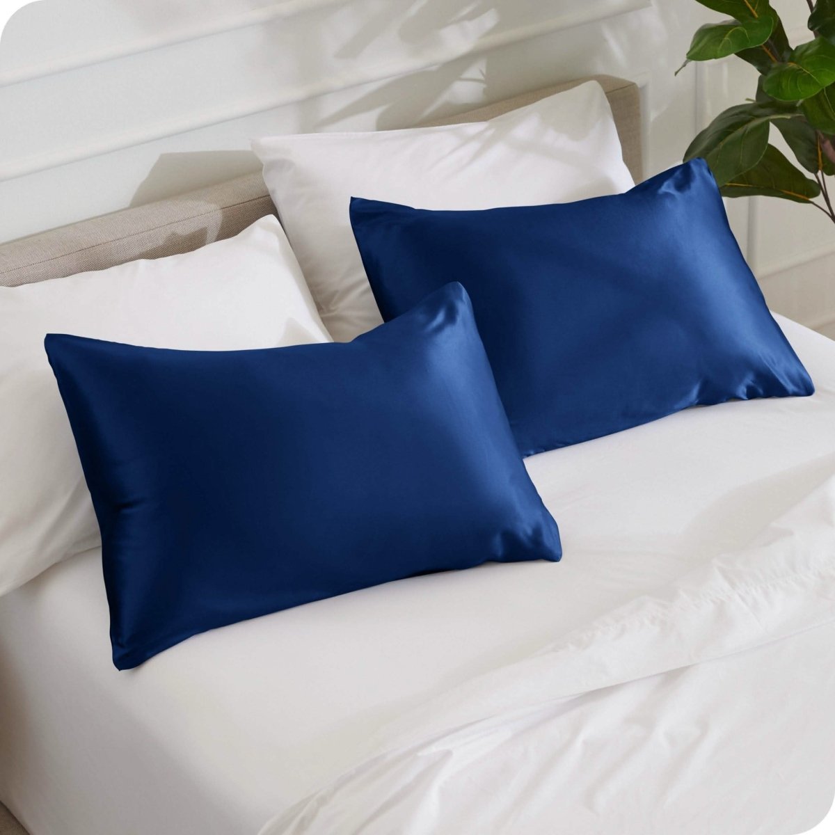 2 mulberry silk pillowcases on pillows set on a bed
