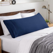 A body pillowcase on a pillow set against a headboard