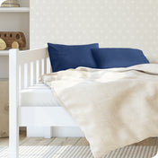 A toddler's bed with 2 microfiber pillowcases on pillows